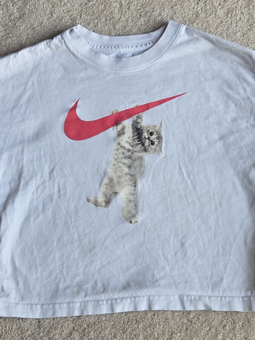 Nike White Tee with Pink Swoosh and Hanging Kitten Graphic